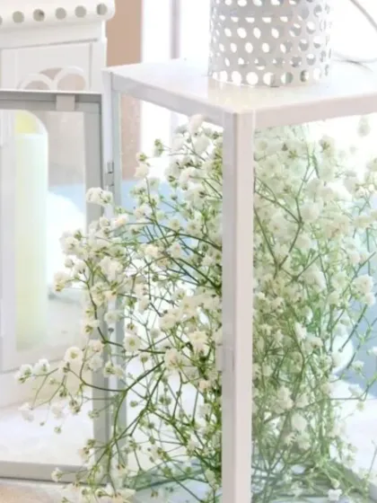 A simple yet beautiful centerpiece idea. I used delicate baby's breath flowers inside a white lantern for a clean and modern look.