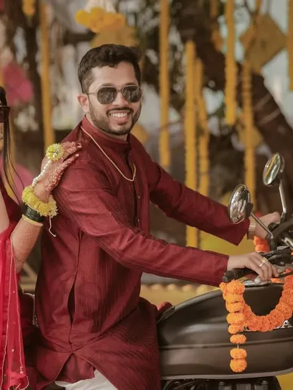 Who says traditional has to be boring? This shot captures a cool, modern vibe with the couple posing on a classic motorcycle, blending ethnic outfits with a bit of fun and swag.
