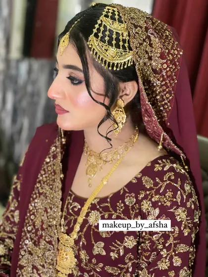 A side view showing the intricate details of the headpiece, which is a traditional Hyderabadi style. The makeup is sharp and defined to complement the grandeur.
