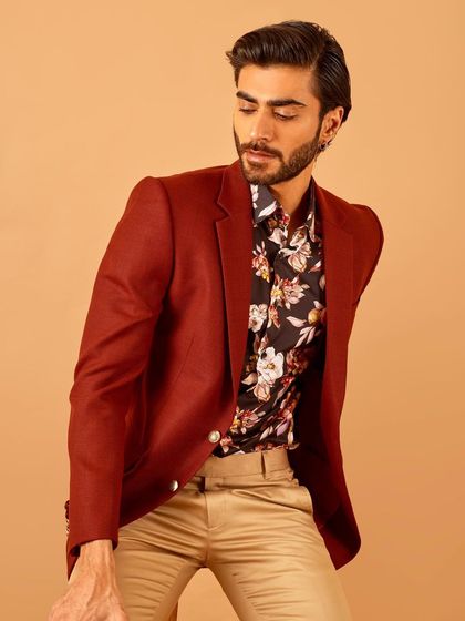 A different pose in the maroon blazer and floral shirt combination, showing how the outfit allows for comfortable movement.