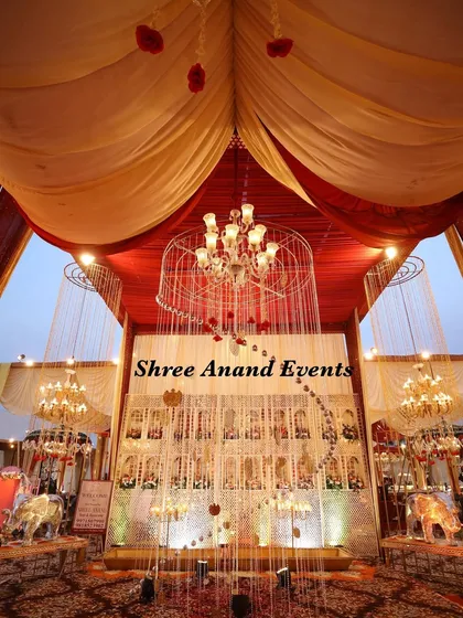 A grand photo opportunity or entrance piece, featuring a large caged chandelier and mirrored elephants, set against a haveli-style backdrop.