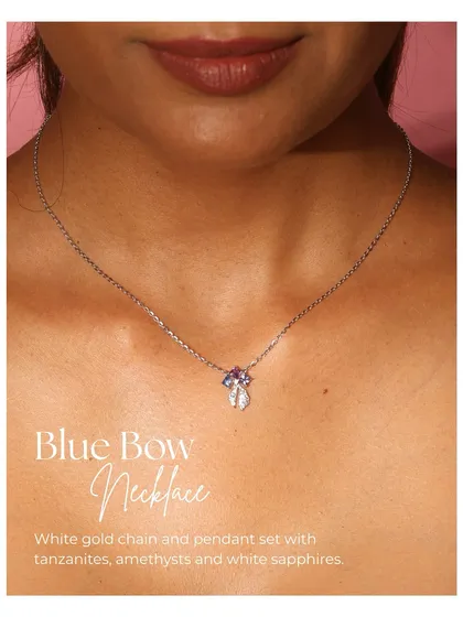 The Blue Bow Necklace, a charming piece in white gold. The pendant is a delicate bow set with tanzanites, amethysts, and white sapphires.