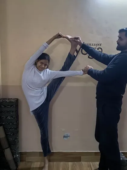 This student demonstrates incredible flexibility in the standing split pose. Our training helps you understand the anatomy and progressive steps to achieve such advanced asanas.