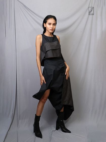 This pose highlights the layered and draped elements of the skirt, perfect for an editorial or designer lookbook.