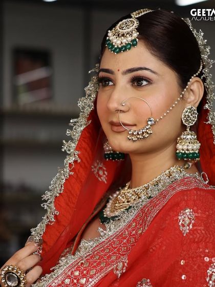 This classic Indian bridal look features a flawless matte base, kohl-rimmed eyes, and traditional green and silver jewelry. Our students learn to create these iconic looks with precision.