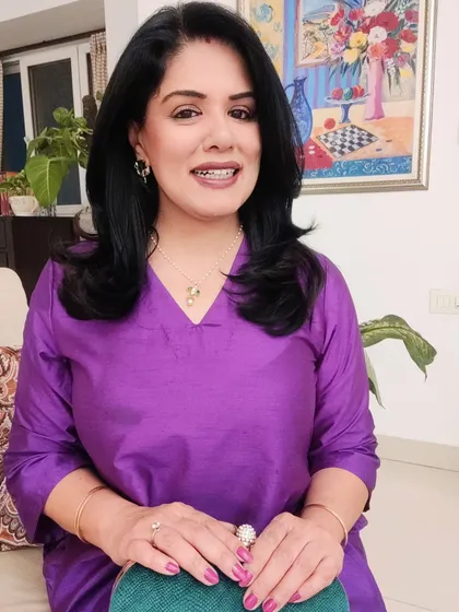 A close-up of the purple kurta look, showing the polki and emerald pendant set that complements the outfit's colour.