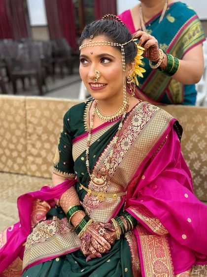 A stunning Peshwai wedding look. The makeup is kept natural and glowing to complement the rich saree and traditional gold jewelry, creating a timeless bridal portrait.