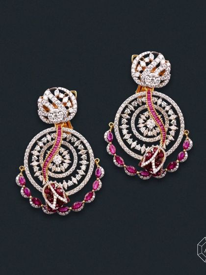 These earrings blend classic elegance with a modern twist, crafted in 18kt gold with a stunning combination of round and marquise diamonds and rich rubies.