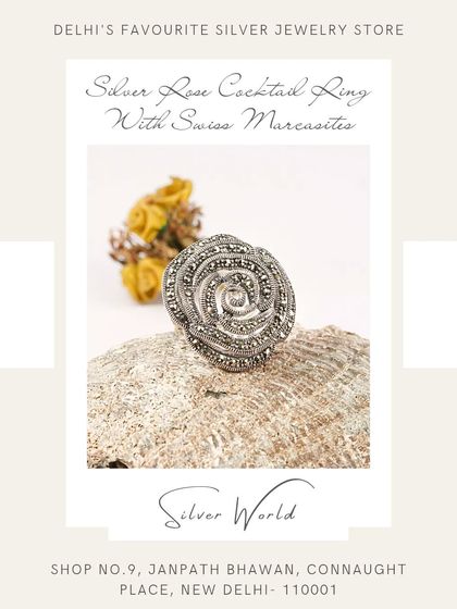 This silver rose cocktail ring is a work of art, with detailed petals and a spiral center, all accented with fine quality Swiss marcasites for a vintage sparkle.