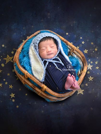 A dreamy, starry night theme for this little one. The bunny-eared bonnet adds a touch of whimsy to this magical portrait in a basket.