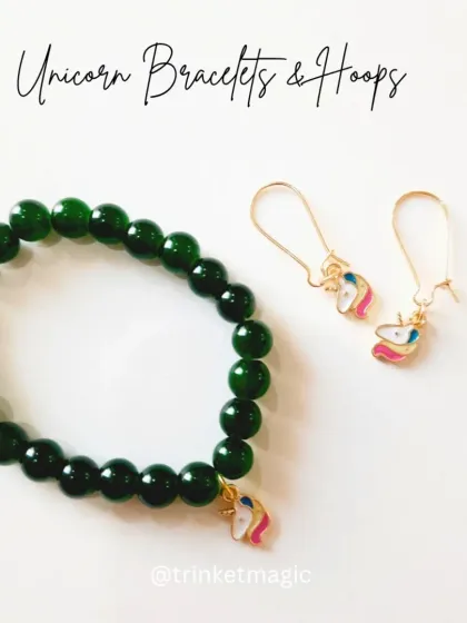 This magical set includes a dark green beaded bracelet and matching hoop earrings, both featuring a cute unicorn enamel charm. Perfect for little girls who love a touch of sparkle.