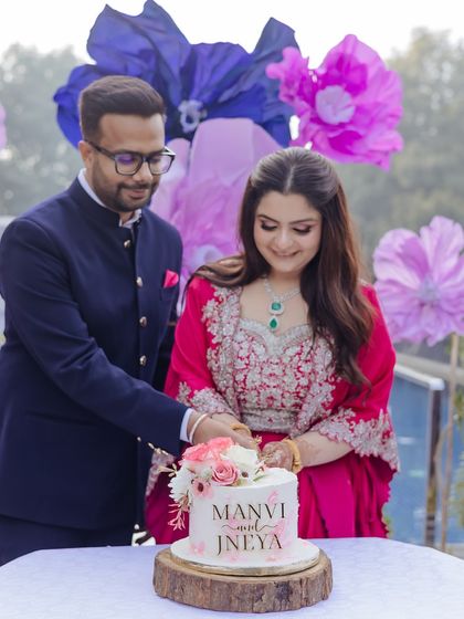 The couple cuts their engagement cake together, a classic moment from their whimsical Roka ceremony.