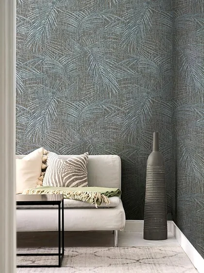A cozy corner enveloped in a textured wallpaper featuring delicate, inlaid fern motifs. This design from Jannelli & Volpi creates a poetic interplay of light and texture, offering a harmonious and sophisticated botanical theme.