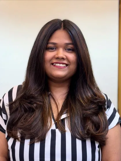 A smiling client happy with her new Mocha Musses hair. It's a subtle trend that makes a big impact.