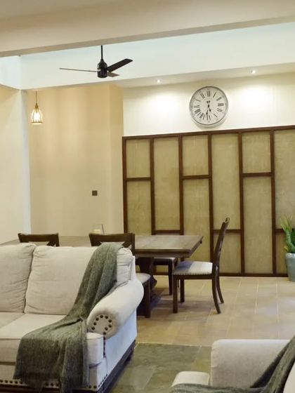 The dining area is defined by a unique, custom-designed partition wall, creating a sense of separation without closing off the space entirely.