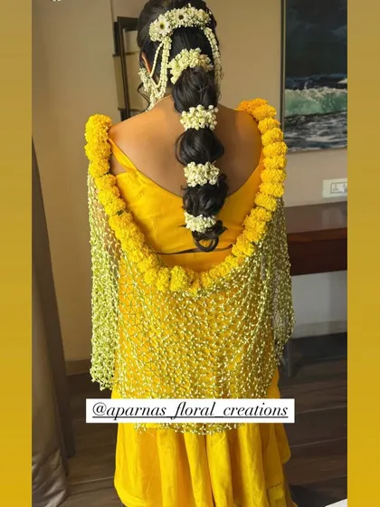 For a vibrant Haldi or Mehendi look, I create floral dupattas and chaddars. This piece features a net of delicate white flowers bordered with bright yellow marigolds, perfectly complementing the yellow ceremony attire.