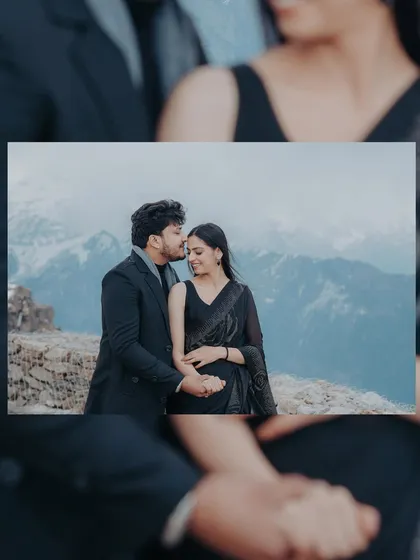 A close-up shot of a couple in the mountains, with the man gently kissing the woman's forehead. This image focuses on the tender connection between them.