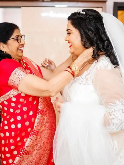 A happy, laughing moment between the bride and her mother during the getting ready process. These lighthearted moments are just as precious.