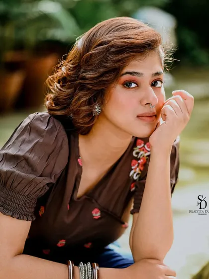 A close-up portrait of actress Ditipriya Roy. The soft, natural lighting and her gentle expression create a fresh and youthful look, while the simple nose ring adds a touch of tradition.