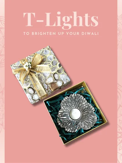 A silver floral T-light holder presented in a beautiful agate-print gift box. This is a perfect, ready-to-gift item for Diwali or any other celebration.