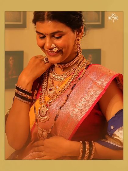 A model looking radiant in a full Maharashtrian bridal jewellery set, including a multi-layered haar and nath.