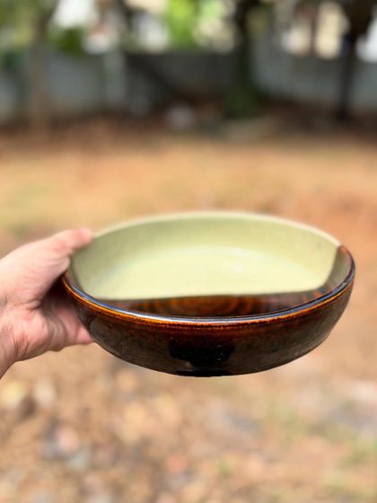 The striking diagonal line on this half-glaze plate separates the earthy tones of our Celadon and the rich darkness of our Tenmoku glaze.