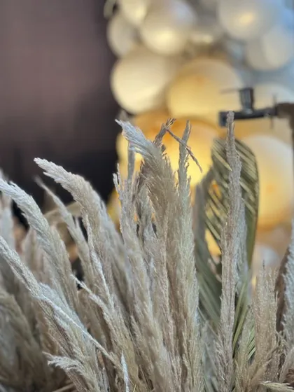 A close-up of the dried pampas grass used in the decor, adding texture and a natural element to the design.