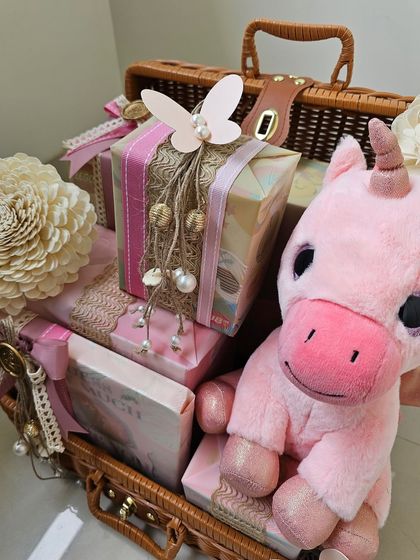 A different angle of the pink trunk, showing how all the beautifully wrapped gifts and the cute unicorn plushie come together to create a truly special present.