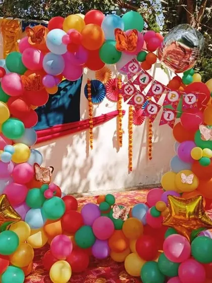 We design fun and vibrant decor for corporate parties. This colorful circular balloon arch, created for an outdoor Holi celebration, serves as a perfect photo booth and adds a burst of energy to the event.