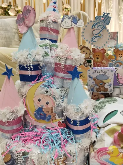An adorable diaper cake at a baby shower. The "He or She" theme adds to the excitement and anticipation.