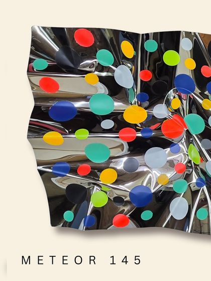 The fluid form of "Meteor 145" catches light from every angle, making the colors pop against the mirrored background.