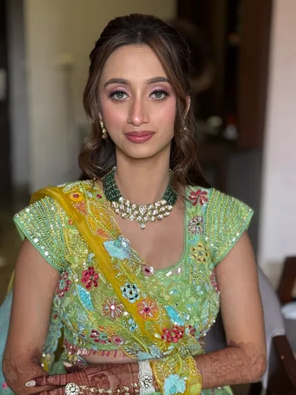 A beautiful portrait of the bride on her Haldi day, with her hair styled in a soft, romantic half-updo.