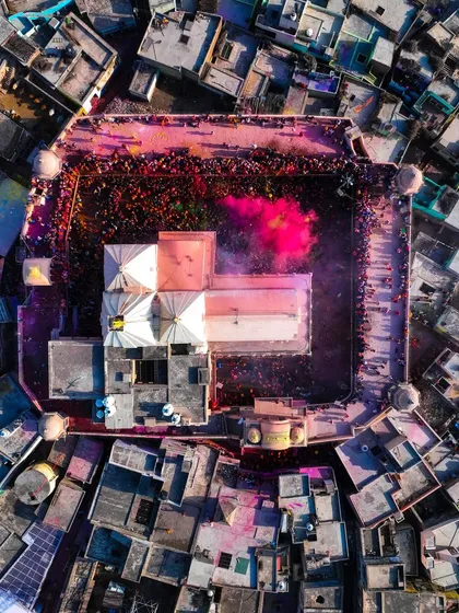 Nandgaon ki Holi 2024. The temple courtyard is a canvas of color. This top-down photo captures the beautiful mess of the celebration.