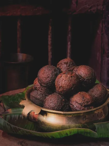 A moody, nostalgic shot of Unniyappam, a traditional Onam snack. This image evokes memories of my grandmother's cooking and the flavors of home.
