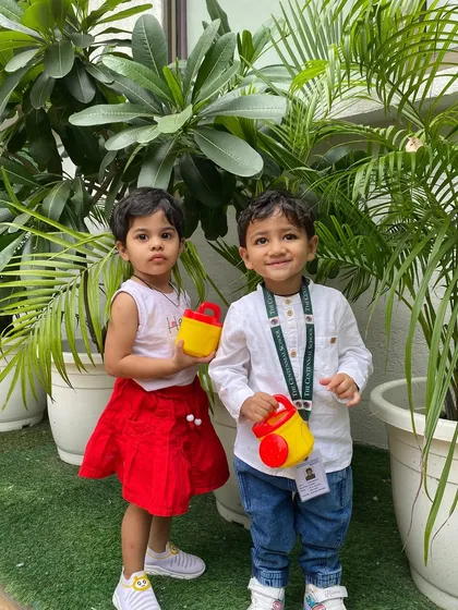 A proud moment for our little gardeners. Taking care of plants helps children develop a nurturing attitude and an appreciation for nature's beauty.