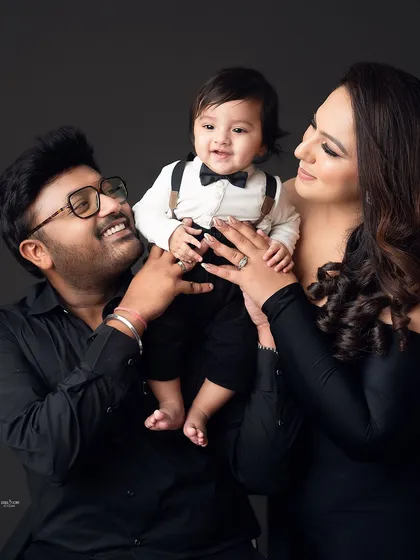 A happy family portrait, with the baby boy as the center of attention.