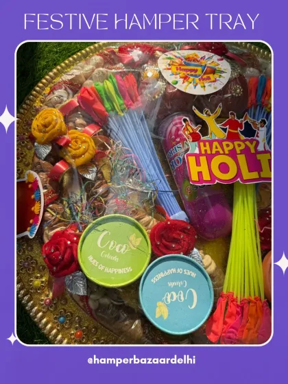 A close up of the contents of our Holi hamper tray. We include a mix of traditional items like gulal and modern treats to ensure there's something for everyone.