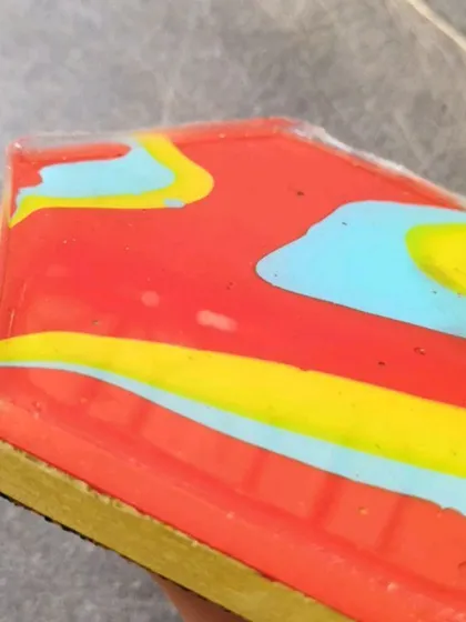 A side view of a coaster, showing the thickness of the concrete base and the smooth, glassy finish of the resin. I pay a lot of attention to these details.