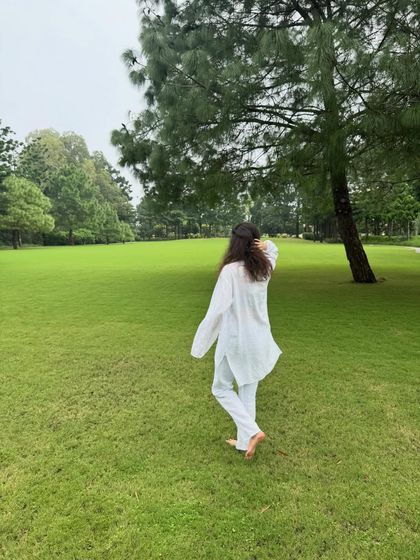 Walking barefoot on the grass, a practice known as 'earthing', allows you to absorb the earth's natural energy. It's a simple way to reduce stress and feel more present in your body.