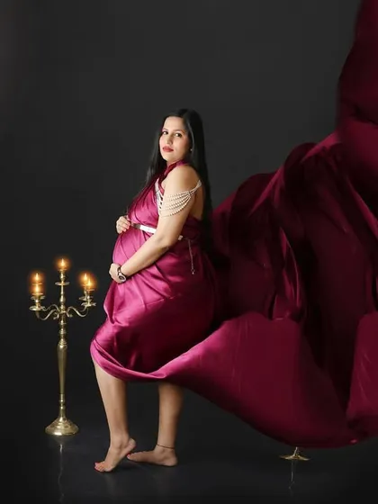 A dramatic fine art portrait with a flowing magenta gown under a full moon. The added candelabra brings a touch of gothic romance to the scene.