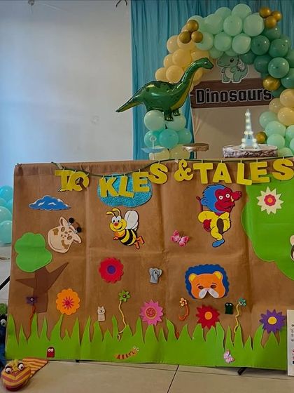 My puppet stage set up for a dinosaur-themed birthday party. The colorful backdrop and friendly puppets create an inviting atmosphere for the kids.