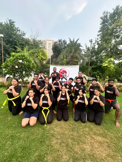 The team gathers for a group photo during our "StrikeHive retreat 2.0". Many participants wear yellow and red belts, showing their progress and dedication.