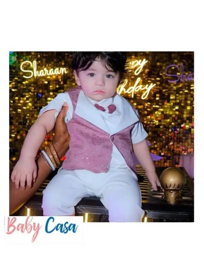 A handsome little man celebrating his birthday. This summer-friendly vest and shorts set is perfect for a party, keeping him cool and stylish.