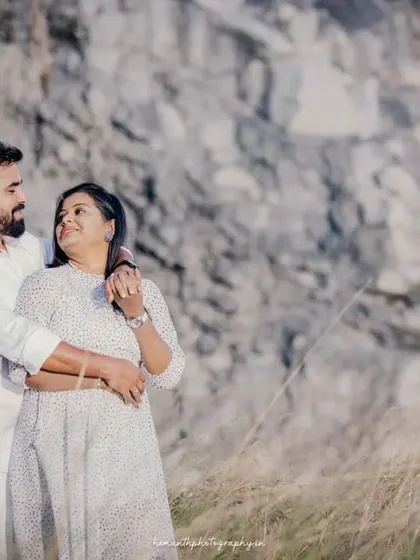 A classic pose for a couple's maternity shoot, highlighting their bond as they look forward to their new arrival. The natural lighting and setting add to the romantic feel.