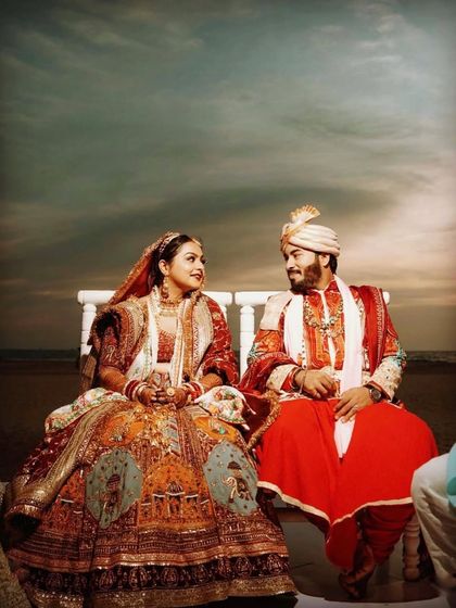 An artistically edited shot of the couple at their beach wedding, creating a dramatic and timeless portrait.