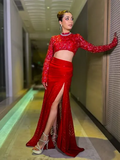A fiery red crop top and slit skirt set, perfect for a reception or cocktail party. This look is modern, bold, and unapologetically glamorous.