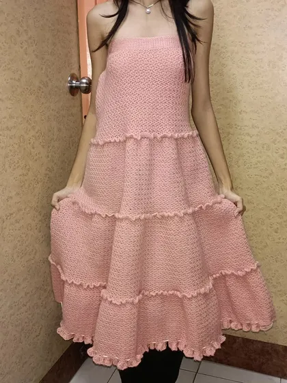 This is the Maloi design, which can be worn as a tiered dress. The soft pink mohair yarn gives it a delicate and ethereal look.