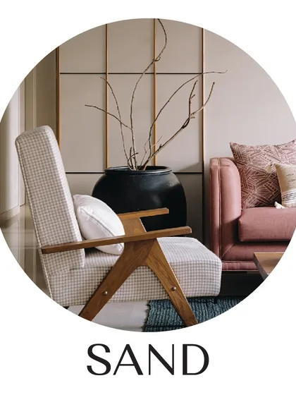 This image, from our 'Sand' project, encapsulates our love for natural textures and warm, neutral palettes. The wooden armchair, the woven rug, and the large ceramic pot with dried branches all come together to create a space that is soothing, cozy, and elegant.