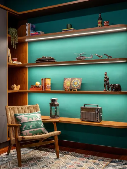 Another view of the 'Vasudhalayah' home office display unit, showcasing how the backlighting and rich green color create a dramatic and beautiful focal point.