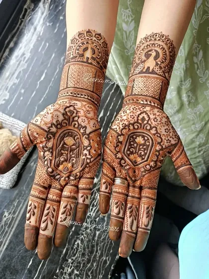 A lovely guest design with a central floral motif and a peacock on the wrist. The surrounding patterns are delicate and intricate, creating a very pretty look.